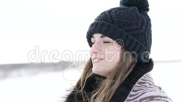 在寒冷的风天特写漂亮女孩的肖像慢慢地视频的预览图