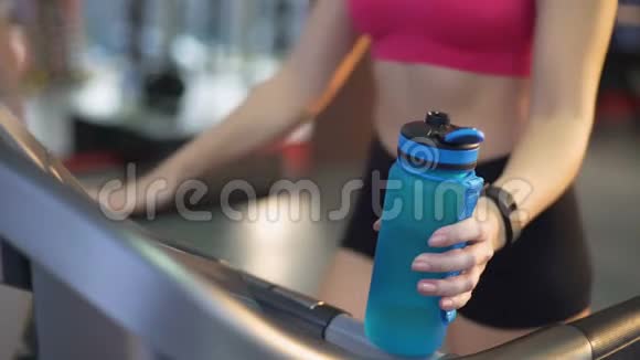 健身女士在跑步机和饮用水上的训练健康饮食控制体重视频的预览图