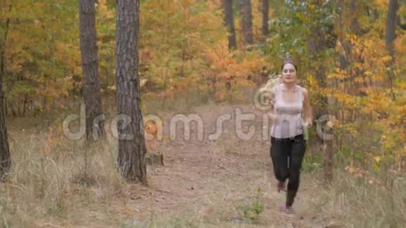 疲惫的年轻女子在慢跑时喘口气视频的预览图