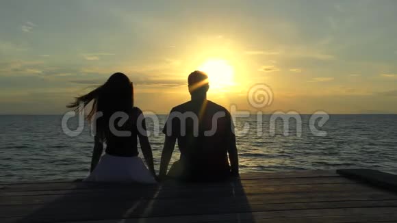 海滩上的浪漫情侣背景是五彩缤纷的日落视频的预览图