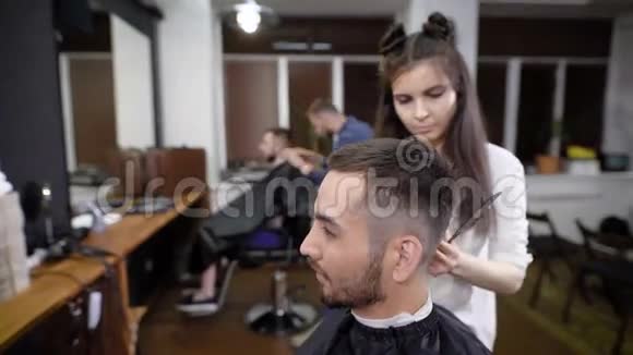 女性和男性为沙龙中的男性顾客做经典时尚发型视频的预览图