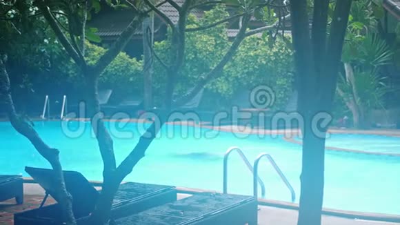 雨天泳池边没有日光浴只是空椅子慢动作3840x2160视频的预览图