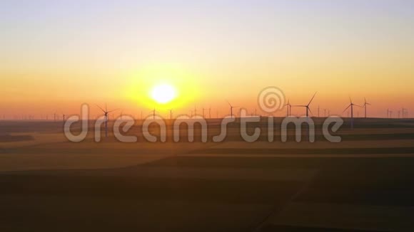 风力涡轮机的空中视图能源生产风车在日出时拍摄风能农场在一个美丽的环境中的欧洲发电机视频的预览图