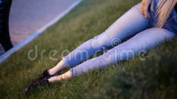 年轻的金发女郎留在草坪上的长发幻灯片视频的预览图