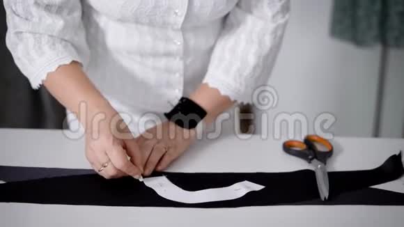 裁缝拿着样板在织物上画衣服视频的预览图
