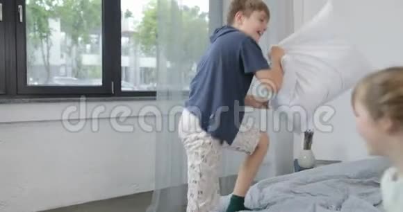 孩子们在父母的床上打架斗殴早上在家欢乐家庭视频的预览图