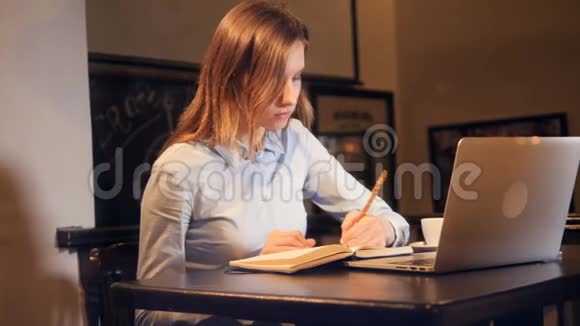 笔记本电脑前拿着一杯咖啡的女孩滑滑梯肖像4K视频的预览图