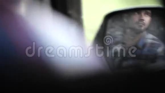 坐在车内拍照的人的侧镜反射视频的预览图