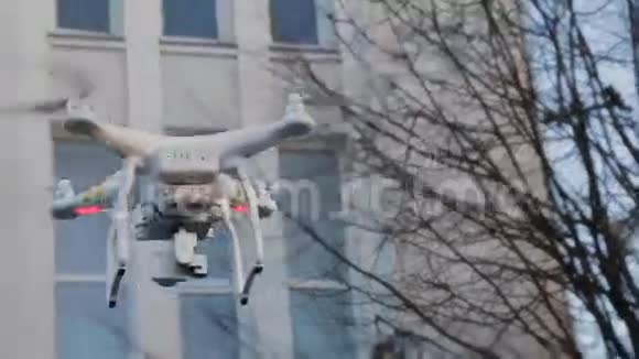 极限特写飞行动作四翼无人机射击飞行城市景观高屋表演动作视频的预览图