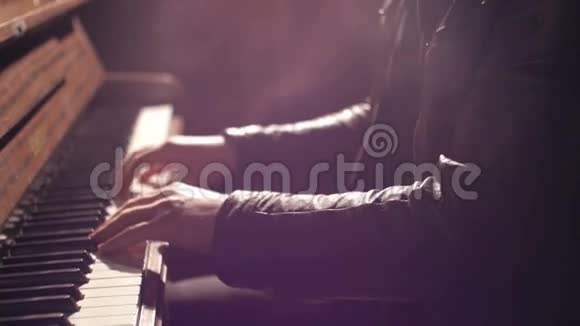 特写镜头一位音乐家手在黑暗的工作室里弹钢琴镜头闪耀视频的预览图