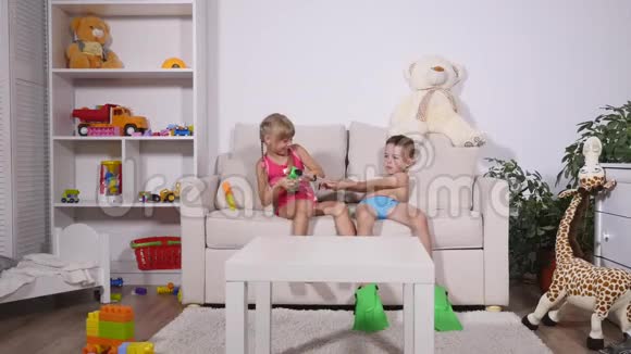 两个戴着潜水面具的快乐孩子坐在沙发上视频的预览图