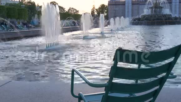 在喷泉附近的公园里一个美丽的休息场所日落时的太阳使水的飞溅神圣化可爱可爱视频的预览图