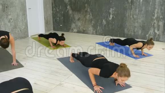 在瑜伽馆室内做瑜伽太阳敬礼姿势的女性视频的预览图