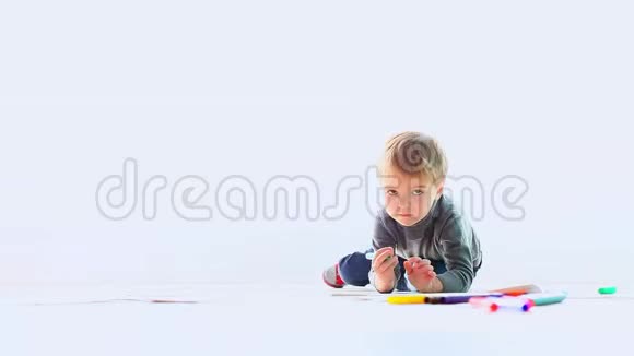 小男孩在地板上用彩色记号笔画图画视频的预览图