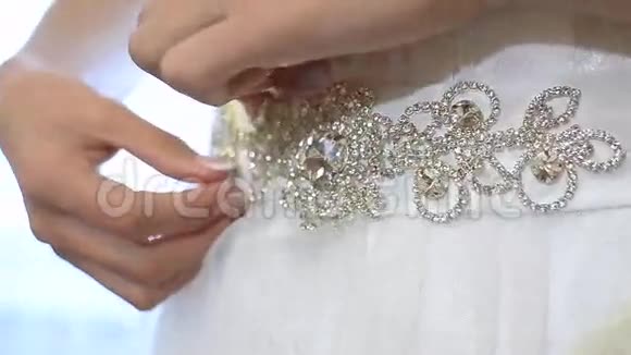 女孩的手拉直装饰在一件白色漂亮的连衣裙上特写视频的预览图