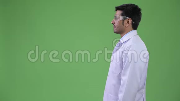 年轻英俊的波斯男子医生戴着防护眼镜的侧影视频的预览图