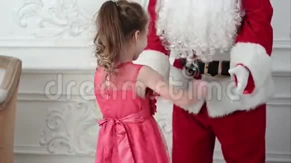 圣诞老人和漂亮的小女孩玩得很开心视频的预览图