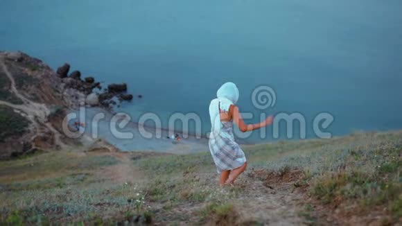 穿着头巾的瘦小少女和穿着山上的歌走向大海视频的预览图