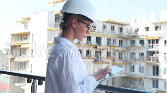 带头盔和平板电脑的女工程师视频的预览图