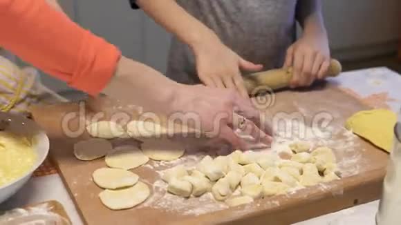 儿子在厨房帮妈妈他们画了一张快乐的面粉准备饺子乌克兰传统美食视频的预览图