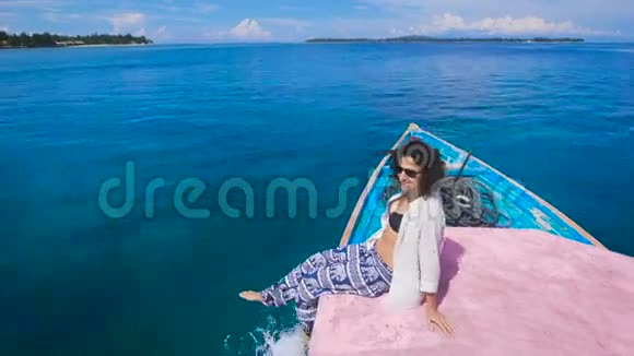 巴厘岛旅游岛上的女孩她坐在船边欣赏着绿松石般的海洋干净利落只是她视频的预览图