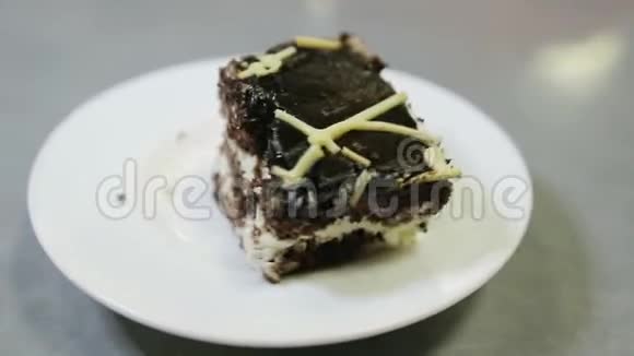 用勺子把一块巧克力蛋糕放在盘子里视频的预览图