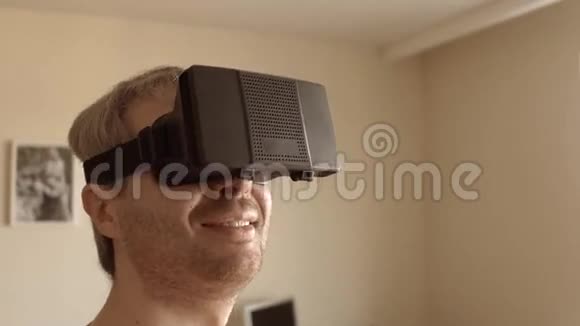 接近灰发男子玩他的手机VR耳机在家里虚拟现实面具在行动4K视频的预览图