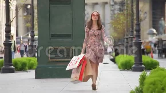 带着购物袋的女人走在街上视频的预览图