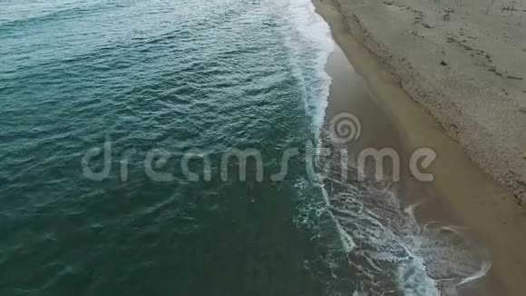 沙滩和干净的水晶水的空中景色海浪拍打视频的预览图