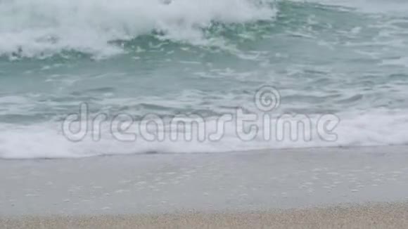 日出时年轻女子沿着海边的腿女孩踩着潮湿的海岸线沙视频的预览图