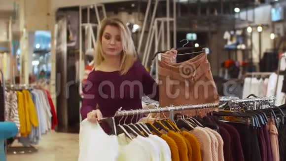 年轻女孩在商店里展示短裤和毛衣视频的预览图