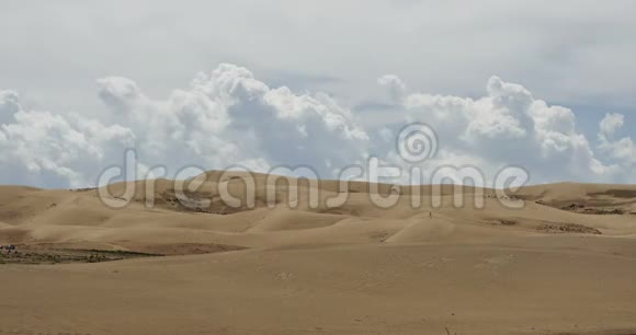 在沙漠沙丘上翻滚的4k时间推移的白色蓬松的大云团视频的预览图