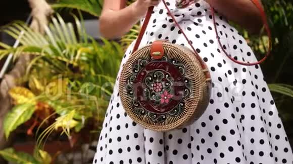 在热带花园里特写时尚的拉坦手袋视频的预览图