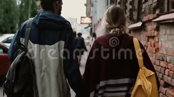 年轻时尚夫妇的后景与背包一起漫步在城市时髦男女的浪漫约会视频的预览图