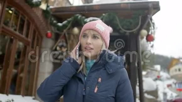 在山区滑雪场打电话的女人视频的预览图