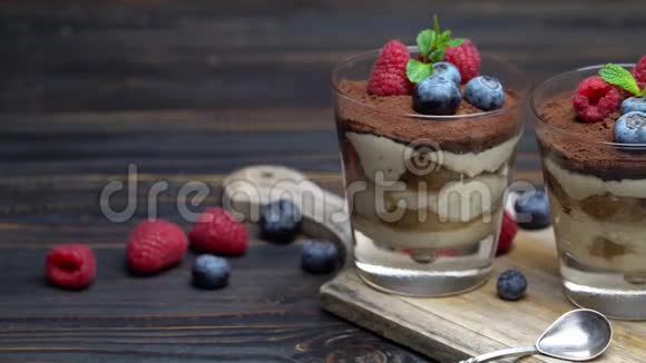 经典的提拉米苏甜点蓝莓和草莓放在切割板上的玻璃杯里视频的预览图
