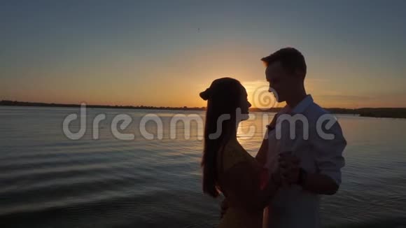 夕阳背景下的情侣接吻剪影视频的预览图