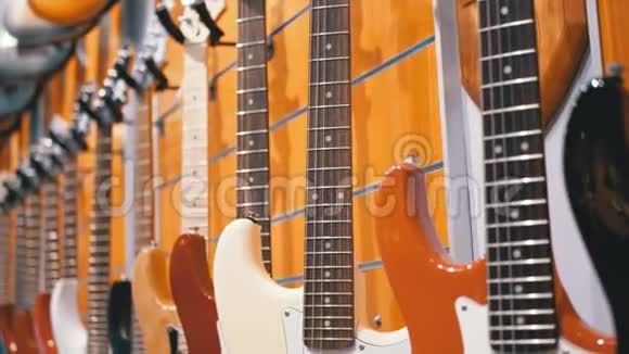 很多电动吉他挂在音乐商店里商店乐器视频的预览图