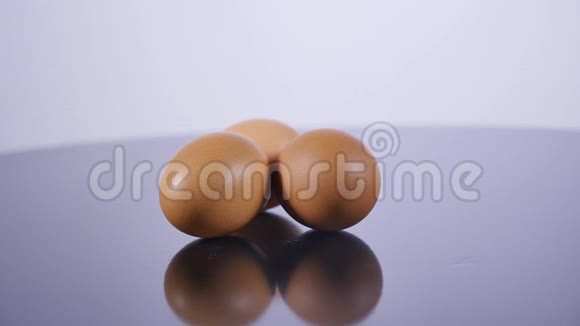 三个生鸡蛋躺在白色的桌子上视频的预览图
