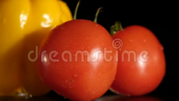 黑背景下的黄铃椒和番茄视频的预览图