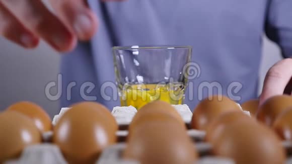 男人手把鸡蛋打碎成玻璃杯慢动作视频的预览图