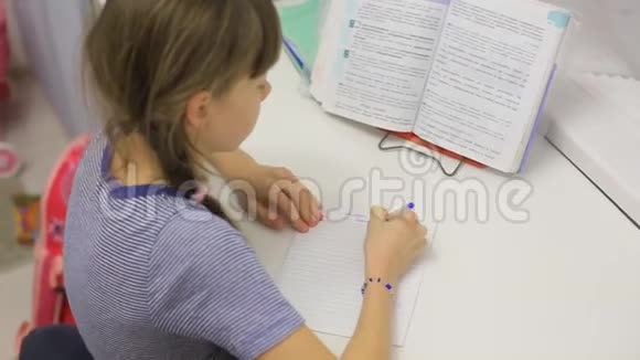 坐在桌子上做作业的少女视频的预览图