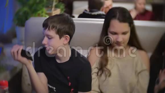 十几岁的朋友坐在咖啡馆里玩得很开心争论不休说脏话青少年问题社会问题视频的预览图