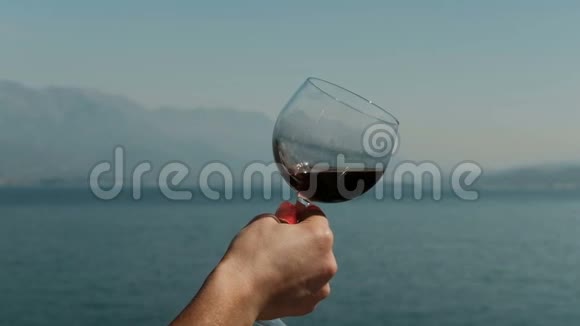 在海上吸入红酒香气的女人的特写镜头视频的预览图