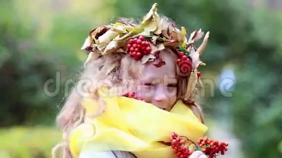 快乐的女孩头上戴着花环秋天的森林里有一片灰烬视频的预览图