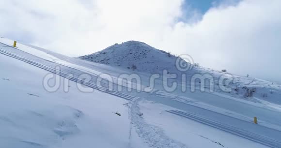 前方高空飞越冬季雪山滑雪跑道场地晴天雾蒙蒙的云雾在上升阿尔卑斯山雪季视频的预览图