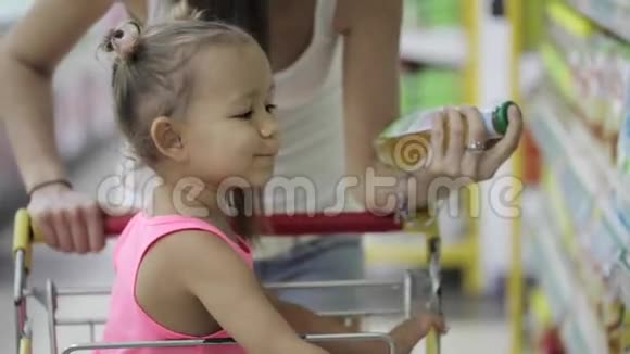 小姑娘带着可爱的女儿在杂货店挑酱视频的预览图