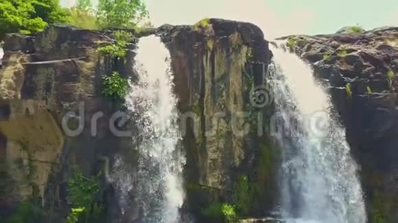 从泡沫瀑布顶端穿过瀑布到池塘的青蛙苍蝇视频的预览图