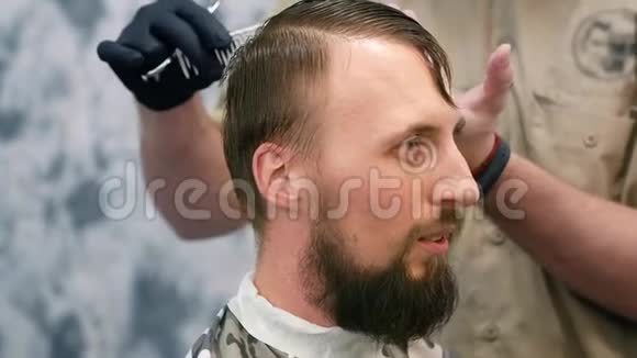 一个理发师正在剪胡子的人视频的预览图