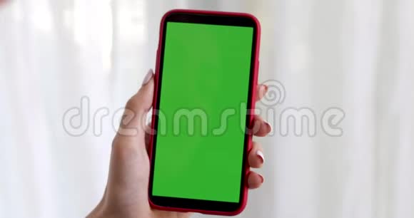 带有绿色屏幕智能手机的女性手视频的预览图